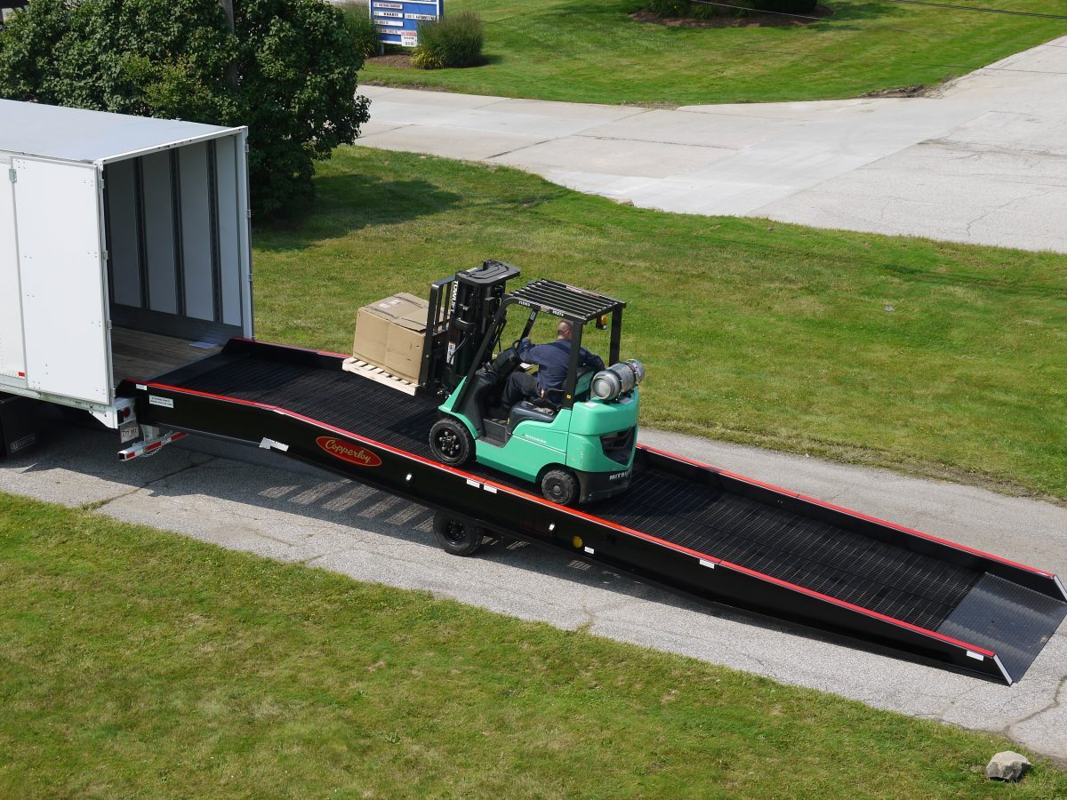 A forklift on a Copperloy portable yard ramp.